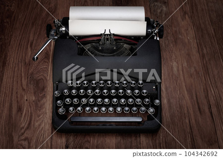 Retro vintage typewriter with paper on table 104342692