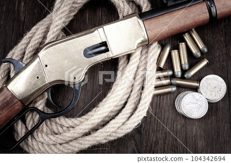 Old west guns. Lever action repeating rifles with ammunition 104342694