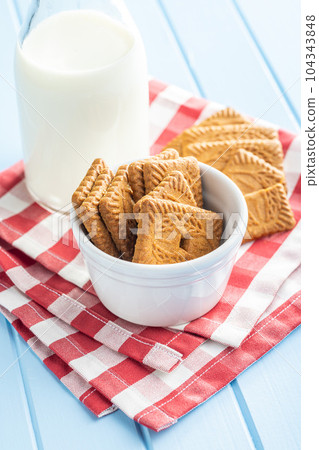Sweet caramel biscuits. Tasty cookies in bowl on checkered napkin. Sweet caramel biscuits. Tasty cookies in bowl on checkered napkin. 104343848