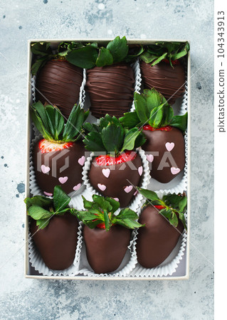 Gourmet chocolate covered strawberries on the light background. 104343913