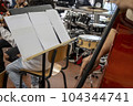 Real life young music students during rehearsals. Musical instruments and music stand with stave. 104344741