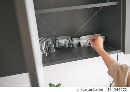 women hand open a kitchen cabinet drawer women hand open a kitchen cabinet drawer 104344972