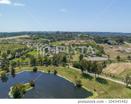 Aerial view over water reservoir and a large dam that holds water. Rancho Santa Fe in San Diego Aerial view over water reservoir and a large dam that holds water. Rancho Santa Fe in San Diego 104345482