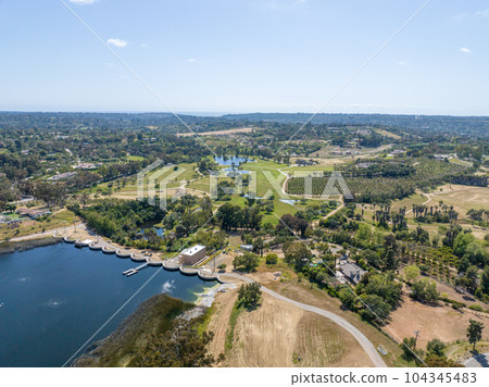 Aerial view over water reservoir and a large dam that holds water. Rancho Santa Fe in San Diego 104345483