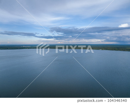 Big lake with green shores in bright sun light, aerial landscape. Recreation concept. Aerial view Big lake with green shores in bright sun light, aerial landscape. Recreation concept. Aerial view 104346340