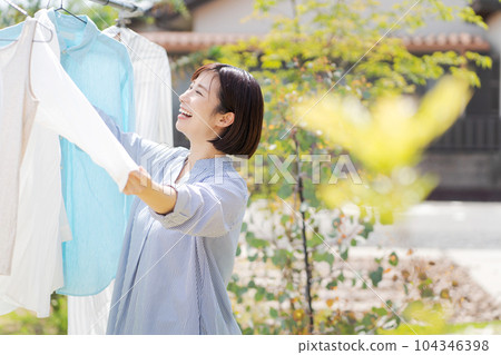 Portrait of a woman doing laundry 104346398