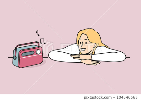 Woman is listening to radio using vintage fm receiver and enjoying analog sound of music 104346563