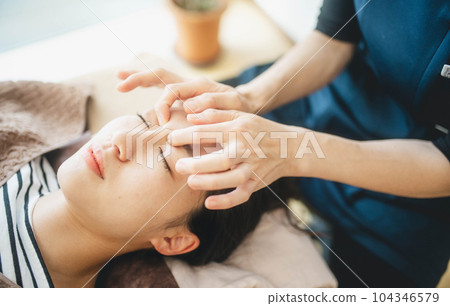 Young woman being massaged around her face 104346579