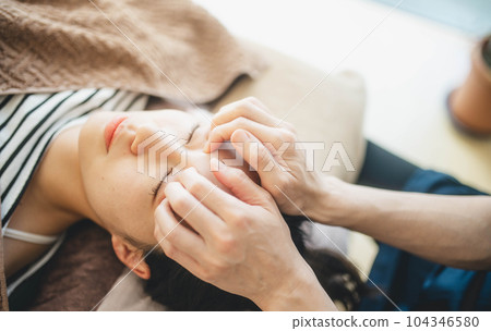 Young woman being massaged around her face 104346580
