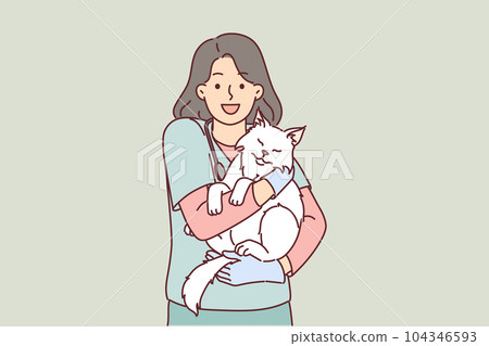 Woman veterinarian holds cat belonging to ZOO clinic visitor who brought pet for vaccination 104346593