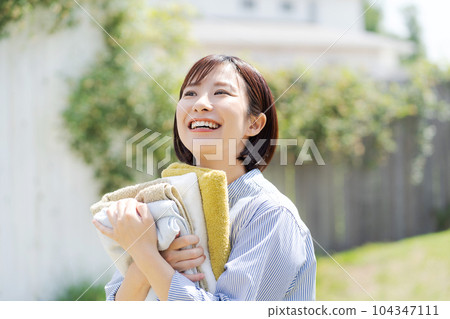 photo of woman with laundry 104347111
