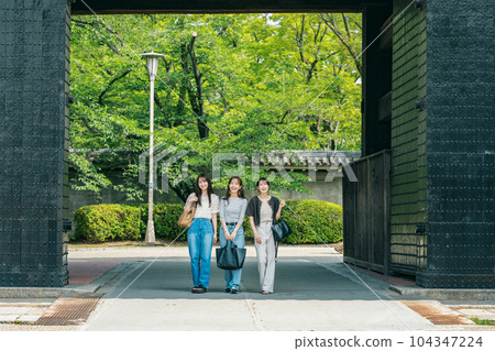 Woman visiting Osaka Castle Park on a trip with friends 104347224