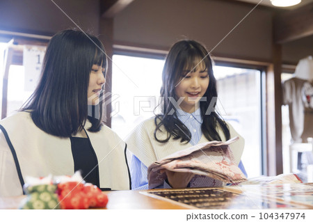 A young woman choosing a yukata at a hot spring facility A young woman choosing a yukata at a hot spring facility 104347974