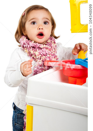 Little blonde girl playing with her toy kitchen 104348099