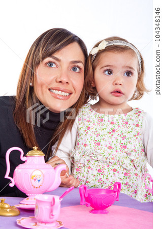 Beautiful little blonde girl playing at home with her mom 104348146