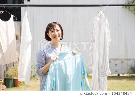 Portrait of housewife doing laundry 104348434