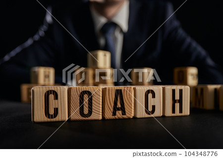 Practice the written word, letters with cubes on the table 104348776