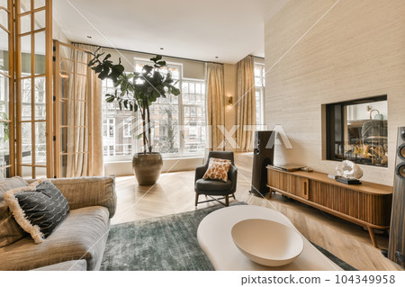 a living room with couches, chairs and a flat screen tv on the wall in the middle of the room a living room with couches, chairs and a flat screen tv on the wall in the middle of the room 104349958