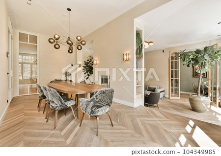 a dining room with wood flooring and white walls, an open door to the living room is in the background a dining room with wood flooring and white walls, an open door to the living room is in the background 104349985
