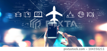 Flight ticket booking concept with a smartphone in city lights at night 104350211
