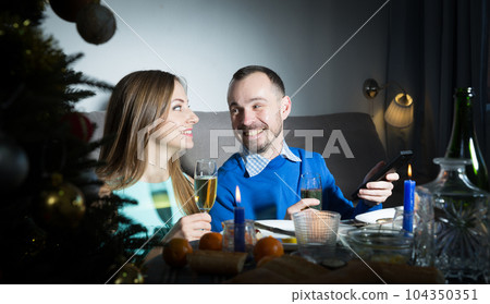 Couple celebrating New Year and watching tv 104350351