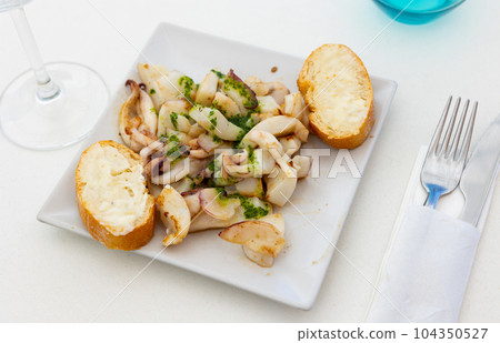 Traditional asian dish is barbecue squid,drizzled with spinach sauce. Traditional asian dish is barbecue squid,drizzled with spinach sauce. 104350527