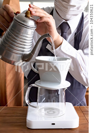 barista pouring hot water barista pouring hot water 104350621