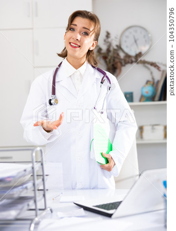 Portrait of positive female doctor with folder Portrait of positive female doctor with folder 104350796