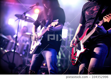 Musical Harmony Guitarists on Stage with Soft Focus and Blur. created with Generative AI Musical Harmony Guitarists on Stage with Soft Focus and Blur. created with Generative AI 104352996