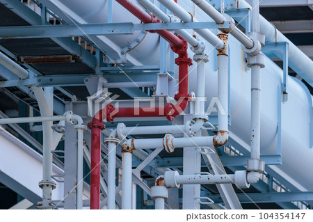 A red pipe that stands out among light blue pipes A red pipe that stands out among light blue pipes 104354147