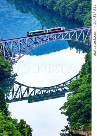 Tadami Line Train crossing the Daiichi Tadami River Bridge in spring (Mishima Town, Fukushima Prefecture, late May early morning) Tadami Line Train crossing the Daiichi Tadami River Bridge in spring (Mishima Town, Fukushima Prefecture, late May early morning) 104354315