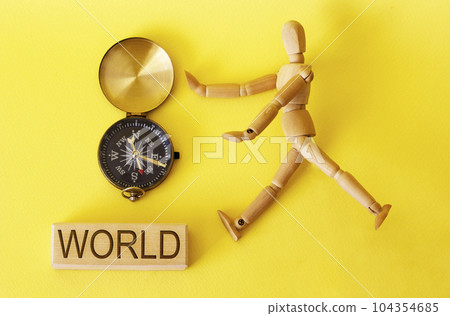on a yellow background compass and text world 104354685