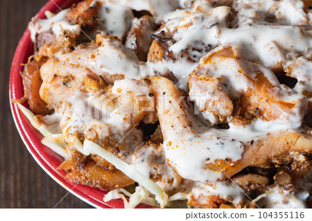 Kebab bowl close-up. A bento box with spicy meat, cabbage, and mayonnaise on rice. 104355116