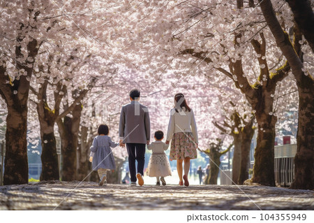 Back view of a family walking along a row of cherry blossom trees in spring "AI-generated image" 104355949