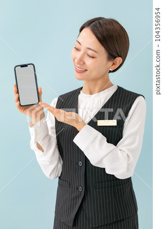 A woman who guides on a smartphone business 104356954