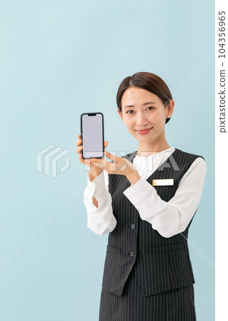 A woman who guides on a smartphone business A woman who guides on a smartphone business 104356965
