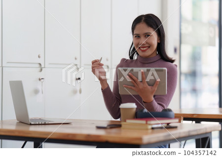 Young student studying in classroom at college. Student working at background. education, back to school concept Young student studying in classroom at college. Student working at background. education, back to school concept 104357142