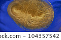 Gold paint flow on blue background. Close-up, shiny golden ink spread, flowing over bright blue surface. Vivid deep color texture. Fluid art. Shiny artwork backdrop. Acrylic gold liquid 104357542