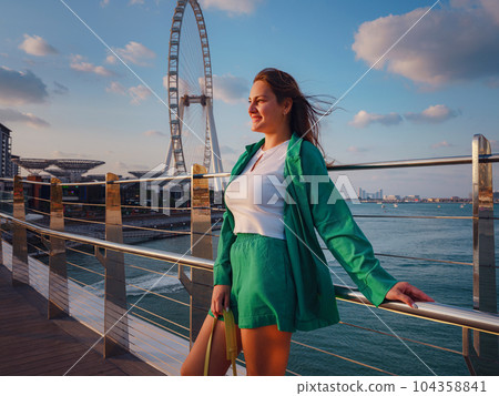 woman walks streets of Dubai, Dubai Marina 104358841