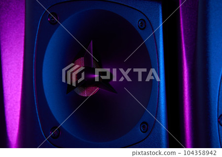 Multimedia acoustic sound speaker with neon lighting. Sound audio system on dark background. Multimedia acoustic sound speaker with neon lighting. Sound audio system on dark background. 104358942