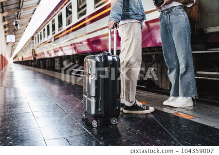 Asian couple at railway station have happy moment. Tourism and travel in the summer Asian couple at railway station have happy moment. Tourism and travel in the summer 104359007