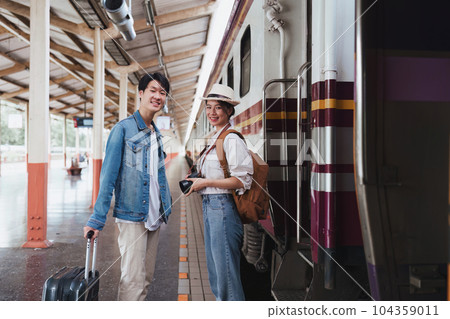 Asian couple at railway station have happy moment. Tourism and travel in the summer 104359011