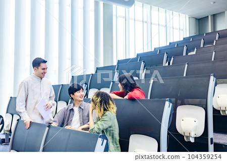Group of multinational students having a conversation in a classroom Group of multinational students having a conversation in a classroom 104359254