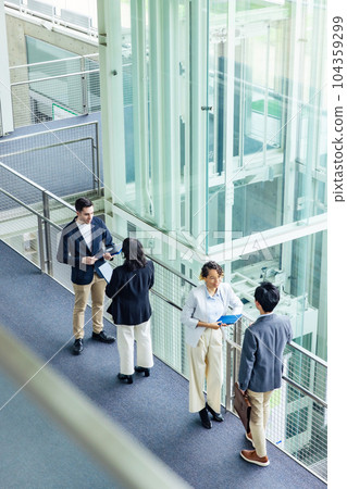 A multinational group having a conversation in the office Bird's eye angle A multinational group having a conversation in the office Bird's eye angle 104359299