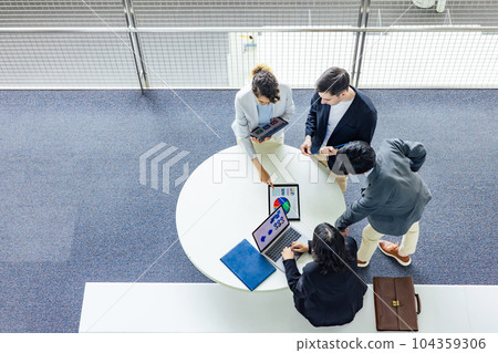 A multinational business group having a conversation in the lobby Bird's-eye angle A multinational business group having a conversation in the lobby Bird's-eye angle 104359306