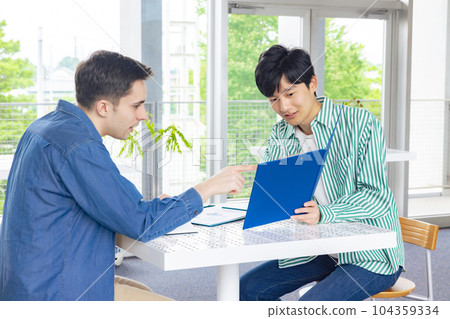 A man talking to a foreign man 104359334