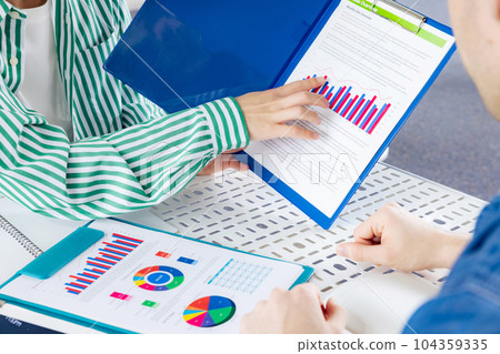 People meeting while looking at documents 104359335