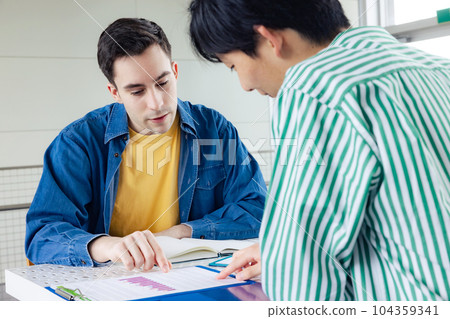 A man talking to a foreign man 104359341