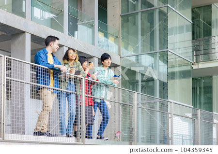 Multinational youth group having a conversation in the lobby 104359345