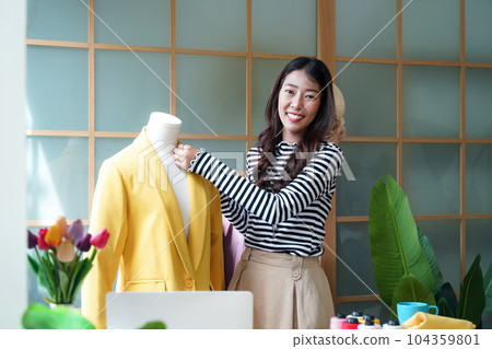 Young women fashion designer using laptop working and design tailor and cloth in the showroom, Young women fashion designer using laptop working and design tailor and cloth in the showroom, 104359801